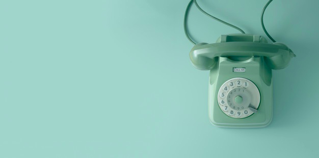 Green vintage telephone with green wall.